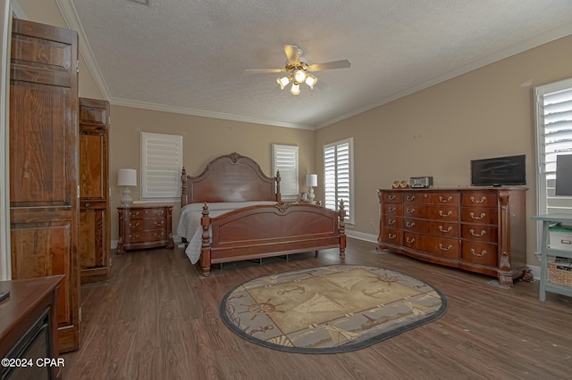 bedroom with ceiling fan, hardwood / wood-style floors, a textured ceiling, and ornamental molding