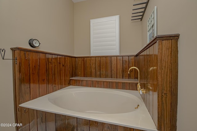 bathroom with a tub to relax in and wooden walls