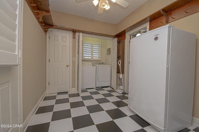 laundry room featuring ceiling fan, washer and clothes dryer, and a textured ceiling