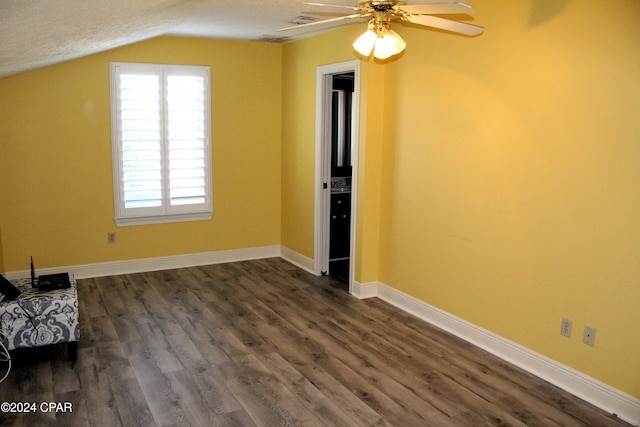 interior space with a textured ceiling, dark hardwood / wood-style flooring, vaulted ceiling, and ceiling fan