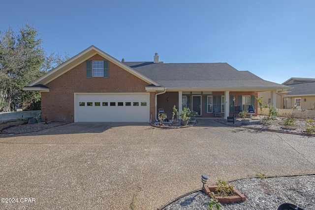 view of front facade with a porch and a garage