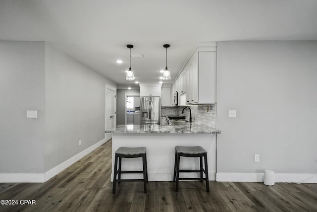 kitchen with stainless steel fridge with ice dispenser, white cabinetry, dark hardwood / wood-style flooring, and sink