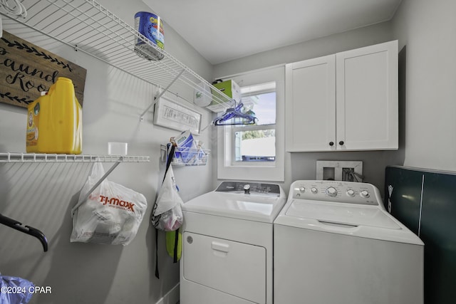 laundry room with cabinets and washer and clothes dryer