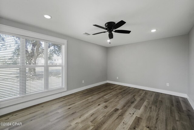 spare room with wood-type flooring and ceiling fan