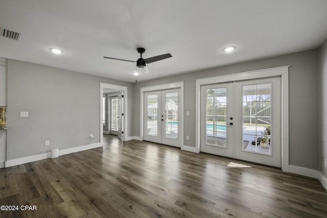 interior space featuring french doors, ceiling fan, and dark wood-type flooring