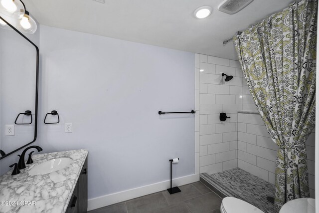 bathroom with walk in shower, tile patterned floors, vanity, and toilet