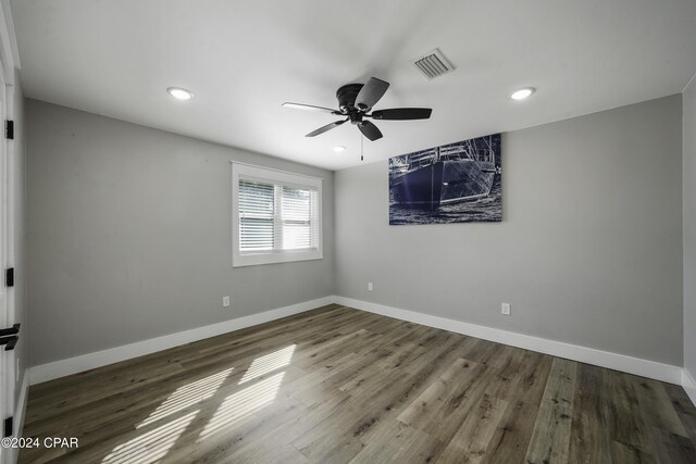 unfurnished room with ceiling fan and hardwood / wood-style flooring