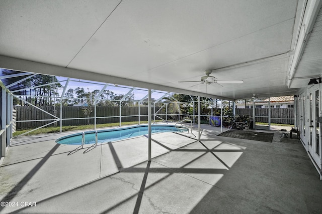 view of pool with ceiling fan, a lanai, and a patio