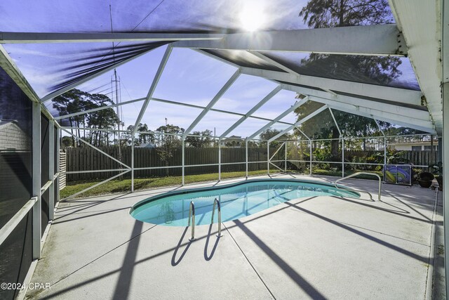 view of pool featuring a patio and glass enclosure