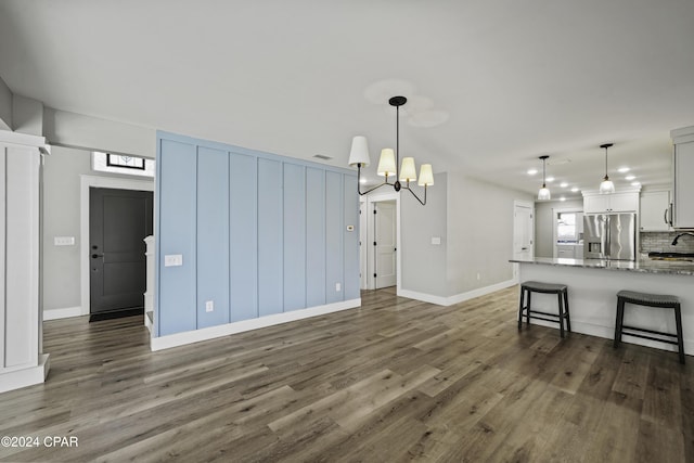 interior space featuring a chandelier and dark hardwood / wood-style floors