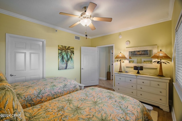 bedroom featuring ceiling fan, ornamental molding, and light tile patterned flooring