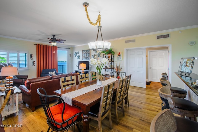 dining space with crown molding and light wood-type flooring