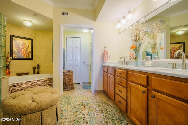 bathroom featuring vanity, a relaxing tiled tub, tile patterned floors, and ornamental molding