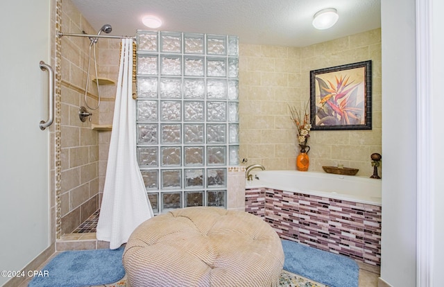 bathroom with tile patterned floors, a textured ceiling, and independent shower and bath