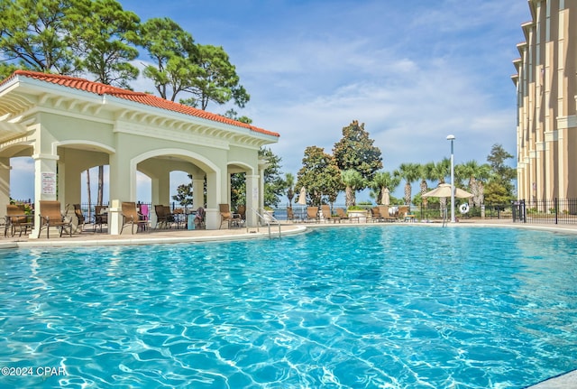 view of swimming pool with a patio