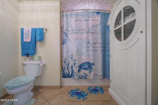 bathroom featuring tile patterned floors, shower / bath combo, and toilet