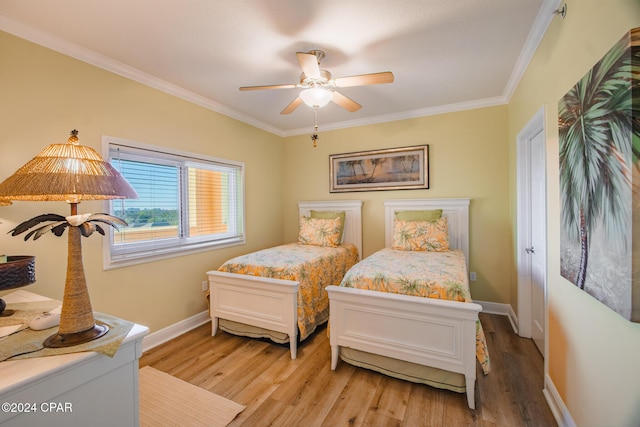 bedroom featuring ceiling fan, light hardwood / wood-style floors, and ornamental molding