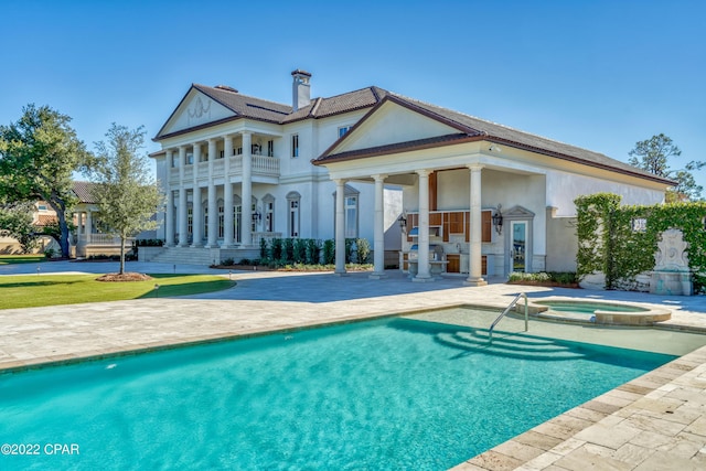 3730 Preserve Bay Blvd, Panama City, FL 32408 - rear view of house with a pool with hot tub, a patio area, and a balcony