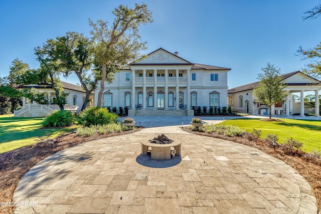 3730 Preserve Bay Blvd, Panama City, FL 32408 - view of front facade with a balcony, a patio, a front yard, and an outdoor fire pit
