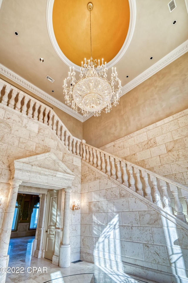 3730 Preserve Bay Blvd, Panama City, FL 32408 - stairs featuring a raised ceiling, crown molding, a high ceiling, and decorative columns