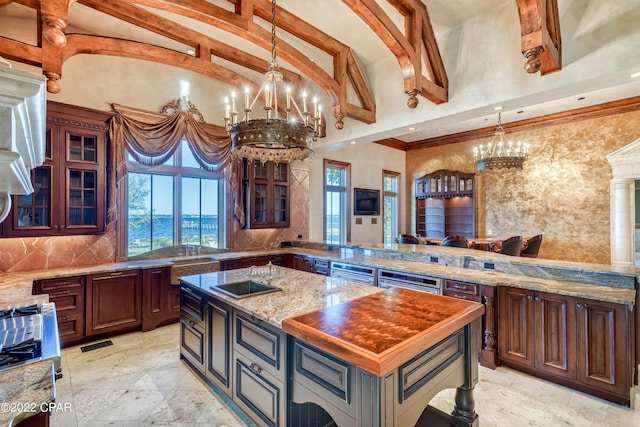3730 Preserve Bay Blvd, Panama City, FL 32408 - kitchen with backsplash, pendant lighting, an inviting chandelier, dark stone countertops, and a center island
