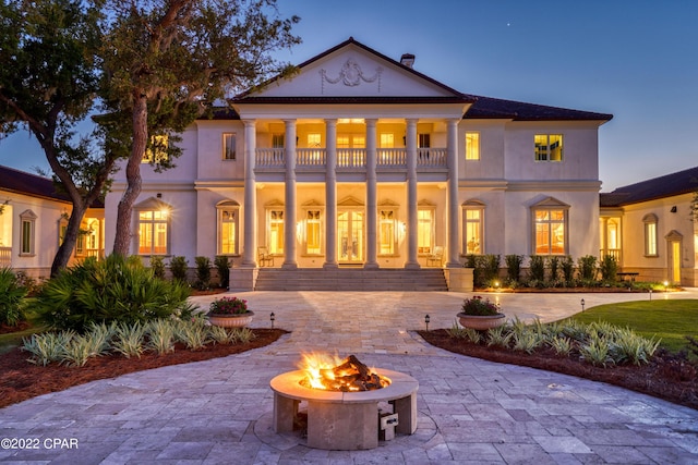 3730 Preserve Bay Blvd, Panama City, FL 32408 - back house at dusk with a balcony and a fire pit