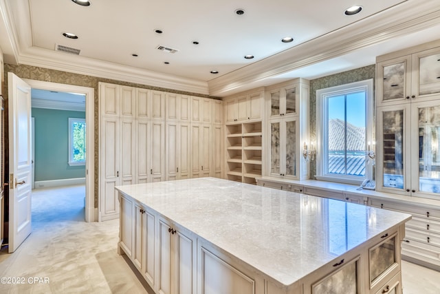 3730 Preserve Bay Blvd, Panama City, FL 32408 - kitchen featuring a kitchen island, light colored carpet, light stone counters, and cream cabinets