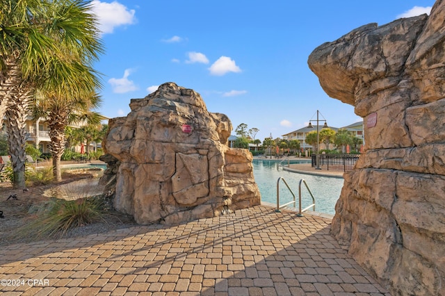 view of pool with a water view