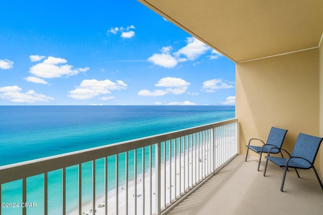 balcony with a beach view and a water view