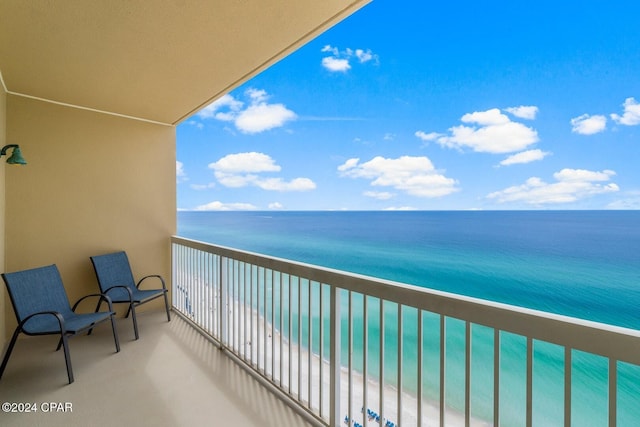 balcony with a water view and a beach view