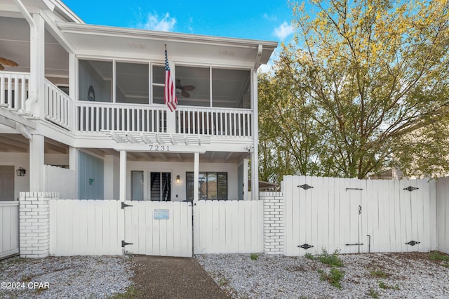 view of front of property with a balcony and a sunroom