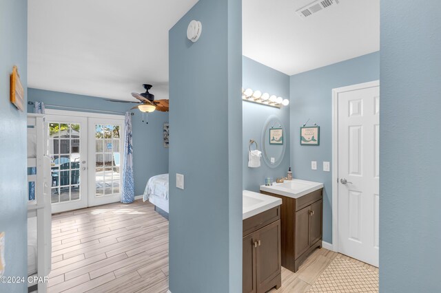 bathroom featuring ceiling fan, wood-type flooring, vanity, and french doors