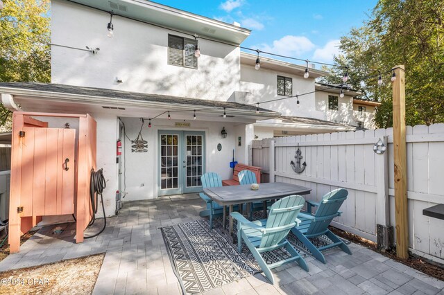 back of property with a patio area and french doors