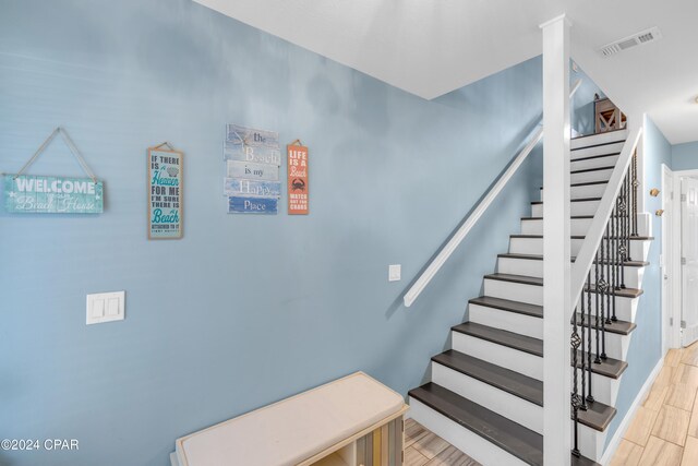 stairs with wood-type flooring