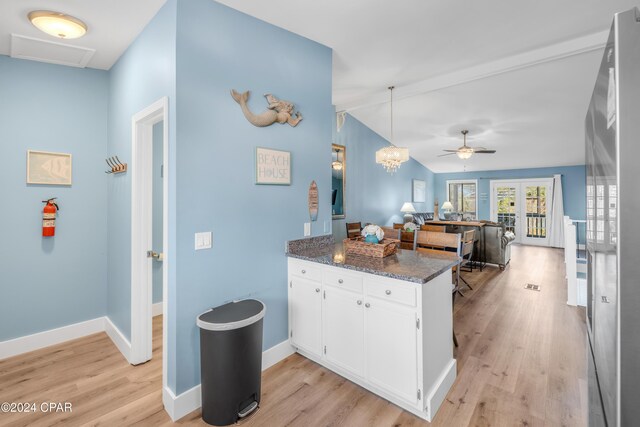 kitchen with kitchen peninsula, white cabinetry, ceiling fan, and light wood-type flooring