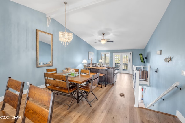 dining area with french doors, vaulted ceiling with beams, light hardwood / wood-style flooring, and ceiling fan with notable chandelier