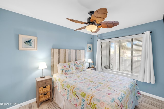 bedroom with ceiling fan and light hardwood / wood-style floors