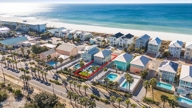 birds eye view of property featuring a beach view, a residential view, and a water view