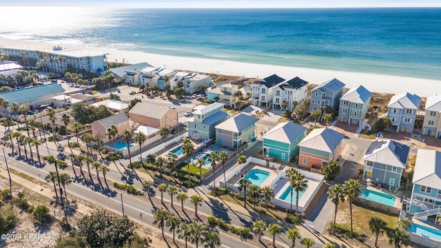 drone / aerial view featuring a water view and a beach view