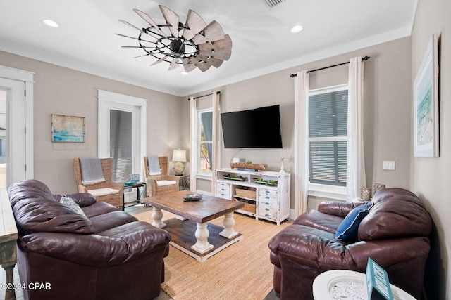 living room with light hardwood / wood-style flooring and crown molding