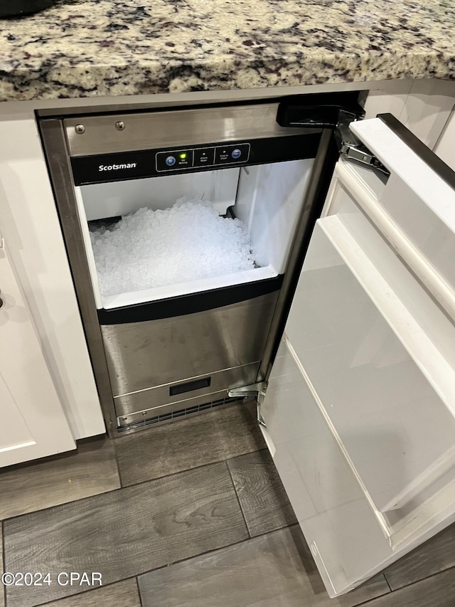 details featuring white cabinets and dark wood-type flooring