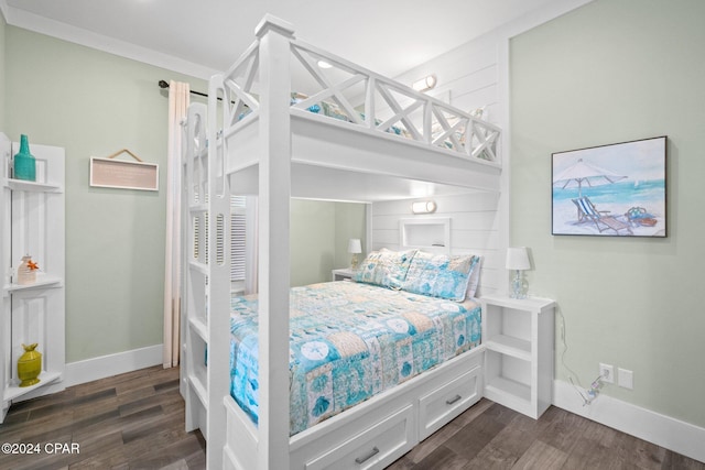 bedroom with crown molding and dark wood-type flooring