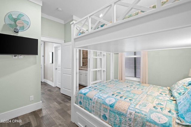 bedroom featuring dark hardwood / wood-style flooring, ensuite bathroom, and ornamental molding