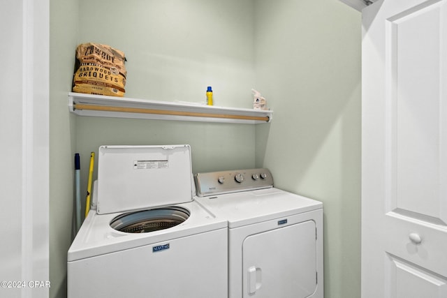 clothes washing area with washing machine and dryer