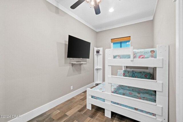 bedroom with ceiling fan, crown molding, and wood-type flooring