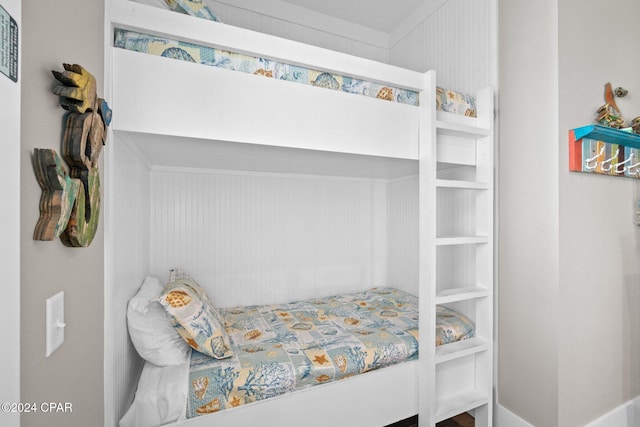 bedroom featuring wood walls