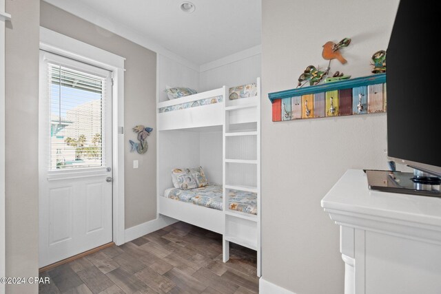 bedroom featuring hardwood / wood-style flooring and crown molding