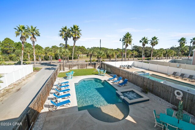 view of swimming pool with an in ground hot tub and a patio