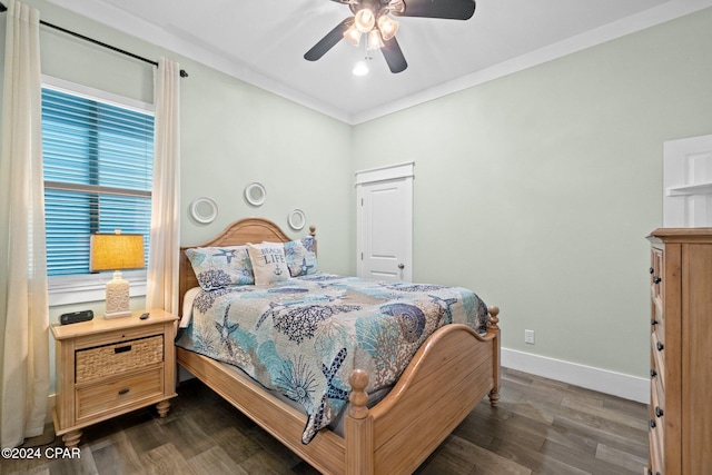 bedroom featuring dark hardwood / wood-style floors, ceiling fan, and ornamental molding