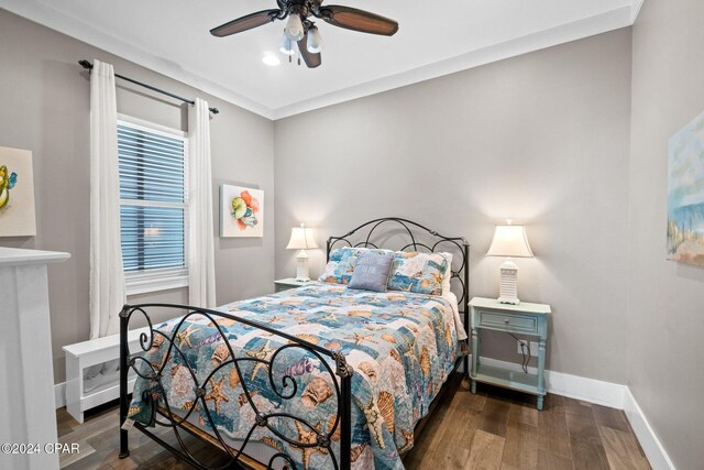 bedroom featuring ceiling fan and dark wood-type flooring